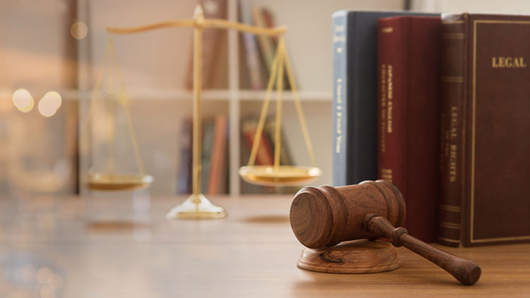  Picture of a gavel and hammer, legal scale balance, and three legal books.